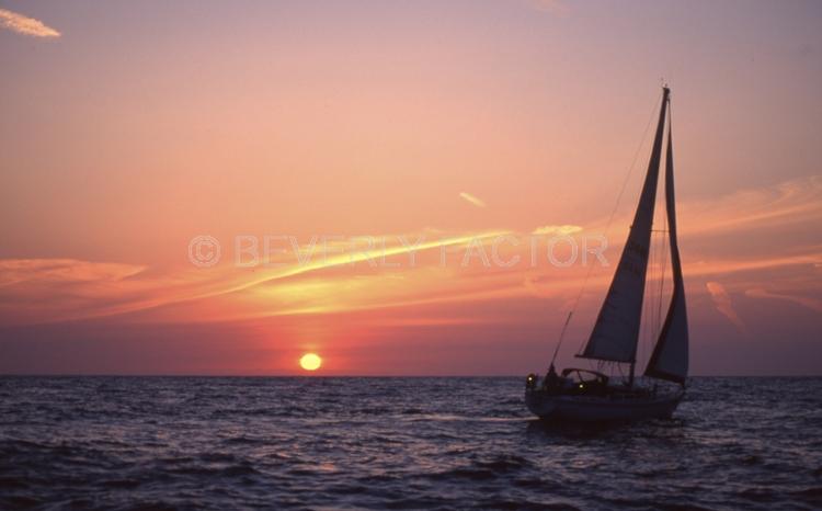 Sunset;colorful;sky;dana point ca;clouds;blue water;sun;yellow;water;boat;red;sillouettes;sailboats;ocean